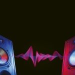 Two,Sound,Speakers,In,Neon,Light,With,Sound,Wave,Between