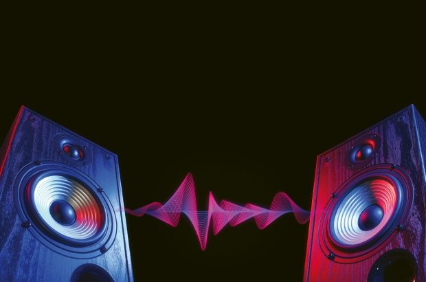 Two,Sound,Speakers,In,Neon,Light,With,Sound,Wave,Between