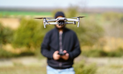 Man,Flying,A,Drone,In,Front,Of,Him,And,Covering