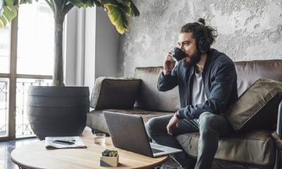 Handsome modern Caucasian man with beard drinking coffee.