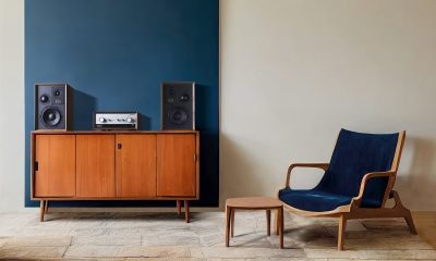 Wooden cupboard next to blue armchair in cozy living